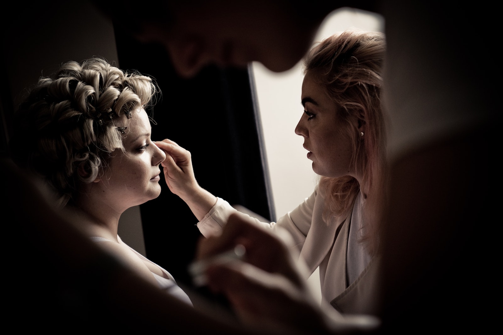Person Putting Makeup On Woman