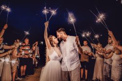 Photo by Victoria Priessnitz man in white dress shirt holding woman in white dress